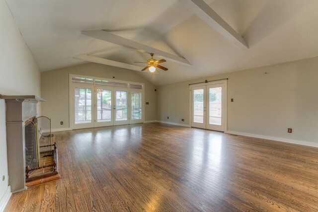 1692 Carruthers Pl, Memphis, TN 38112 - unfurnished living room with ceiling fan, wood finished floors, a fireplace with raised hearth, and french doors