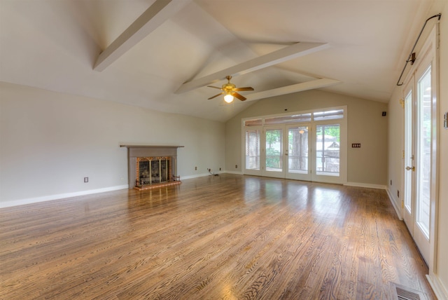 1692 Carruthers Pl, Memphis, TN 38112 - unfurnished living room with plenty of natural light, ceiling fan, a brick fireplace, and wood finished floors