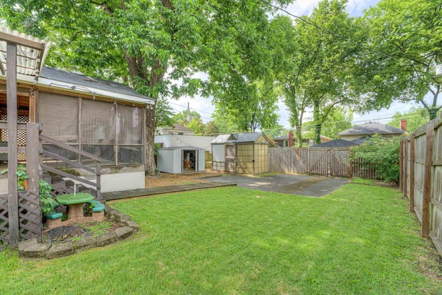 1692 Carruthers Pl, Memphis, TN 38112 - fenced backyard with a shed, a sunroom, and a gate