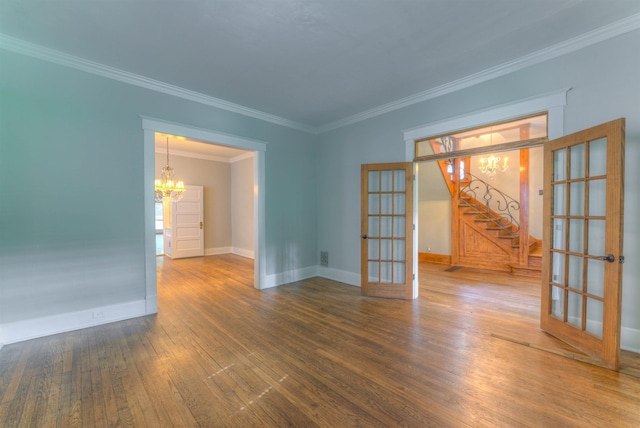 1692 Carruthers Pl, Memphis, TN 38112 - spare room with french doors, a chandelier, wood finished floors, ornamental molding, and stairs