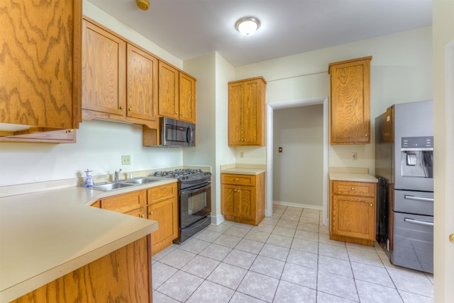 1692 Carruthers Pl, Memphis, TN 38112 - kitchen featuring appliances with stainless steel finishes, light countertops, light tile patterned floors, and brown cabinets