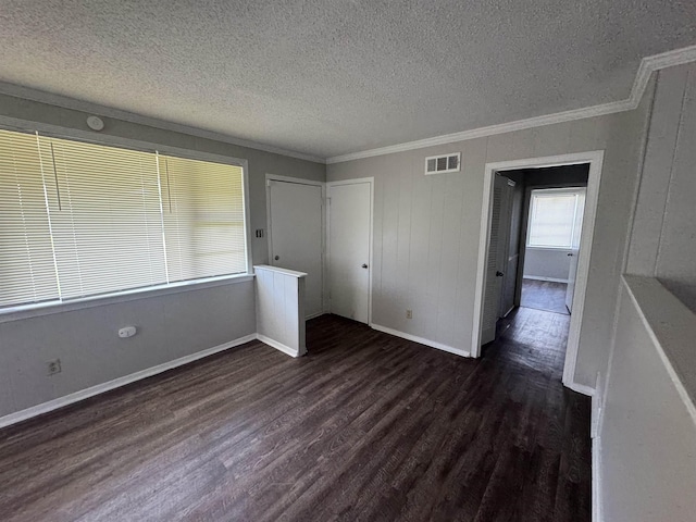 3026 Dearing Rd, Memphis, TN 38118 - spare room with dark wood-style floors, ornamental molding, and a textured ceiling
