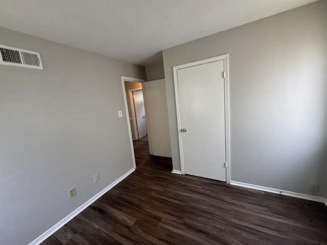 3026 Dearing Rd, Memphis, TN 38118 - unfurnished bedroom featuring dark wood-type flooring and baseboards