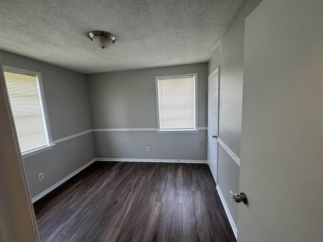 3026 Dearing Rd, Memphis, TN 38118 - empty room with dark wood-style floors, plenty of natural light, and a textured ceiling