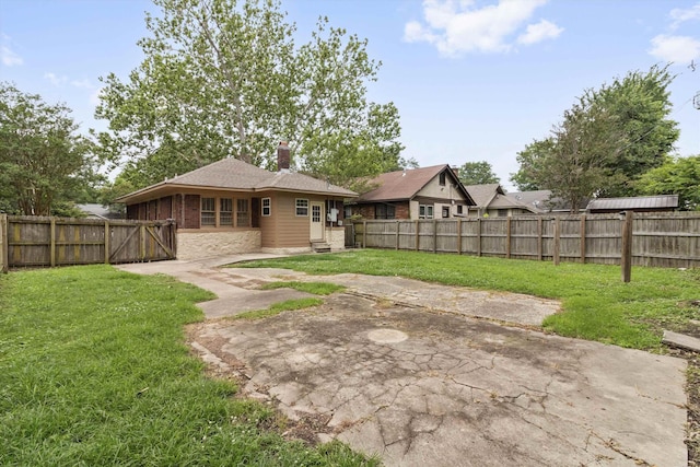 730 Maury St, Memphis, TN 38107 - rear view of house with a patio, a fenced backyard, a chimney, and a shingled roof