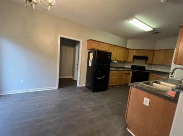 1017 Cordova Ridge Pl, Cordova, TN 38018 - kitchen featuring freestanding refrigerator, electric stove, dark countertops, a chandelier, and brown cabinetry