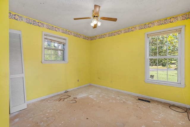 18 County Road 252nd Rd, Glen, MS 38846 - unfurnished room featuring a textured ceiling, healthy amount of natural light, ceiling fan, and concrete flooring