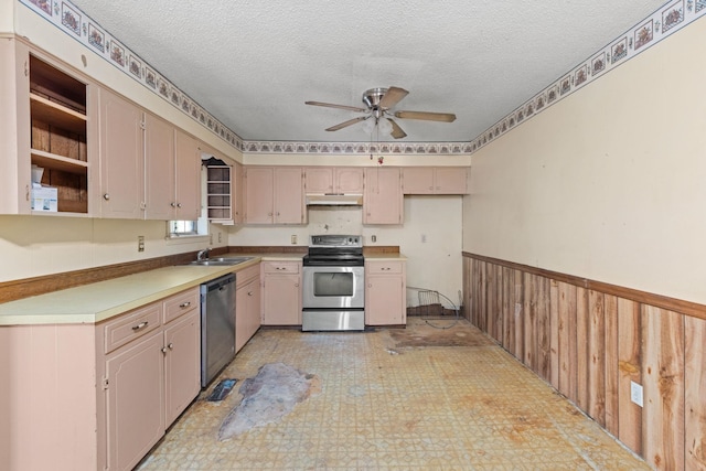 18 County Road 252nd Rd, Glen, MS 38846 - kitchen featuring appliances with stainless steel finishes, ceiling fan, a textured ceiling, light countertops, and a wainscoted wall