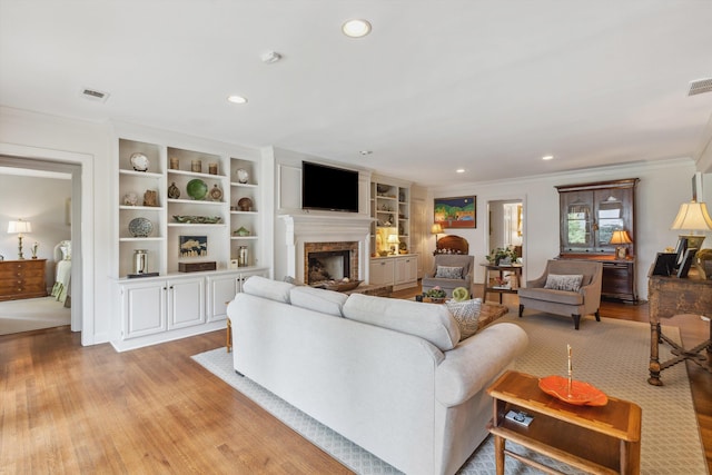 215 Belhaven St, Memphis, TN 38117 - living area featuring crown molding, a fireplace, light wood-style floors, recessed lighting, and built in features