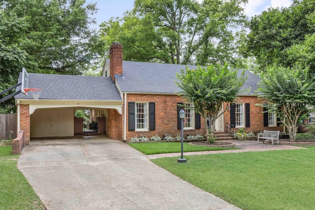 215 Belhaven St, Memphis, TN 38117 - view of front of property with a shingled roof, a front yard, a chimney, and concrete driveway