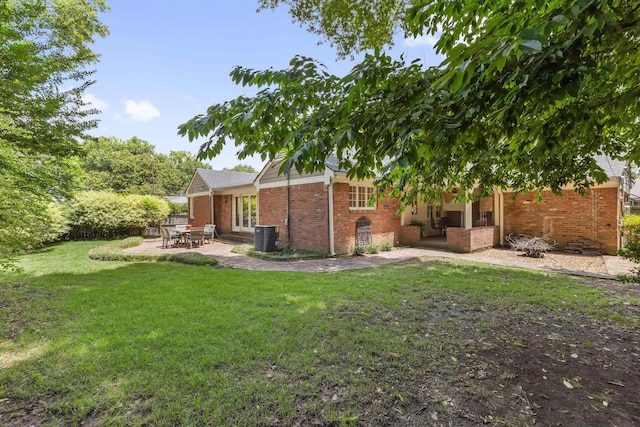 215 Belhaven St, Memphis, TN 38117 - rear view of house with brick siding, a patio, and a yard