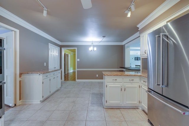 2030 Quail Creek Cv, Memphis, TN 38119 - kitchen featuring high end refrigerator, track lighting, a peninsula, white cabinets, and ornamental molding