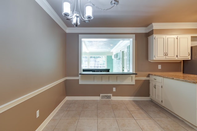 2030 Quail Creek Cv, Memphis, TN 38119 - unfurnished dining area with a chandelier, light tile patterned floors, and crown molding