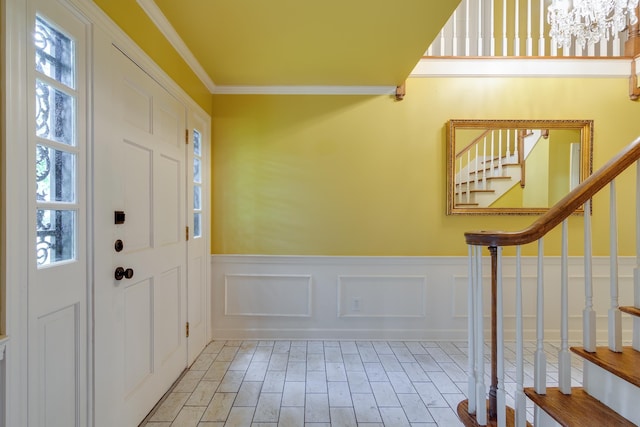2030 Quail Creek Cv, Memphis, TN 38119 - entryway with stairway, a wainscoted wall, crown molding, a chandelier, and wood finished floors