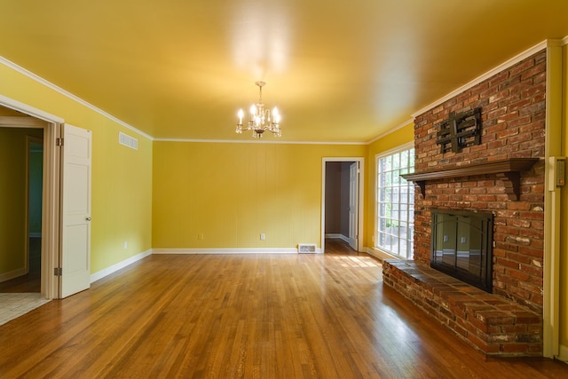 2030 Quail Creek Cv, Memphis, TN 38119 - unfurnished living room featuring hardwood / wood-style flooring, a fireplace, ornamental molding, and a chandelier