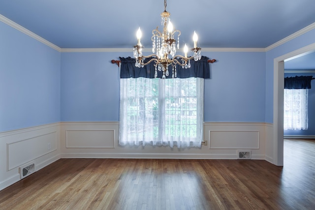 2030 Quail Creek Cv, Memphis, TN 38119 - unfurnished dining area featuring a chandelier, wainscoting, wood finished floors, and ornamental molding