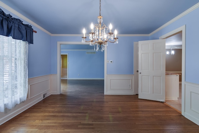 2030 Quail Creek Cv, Memphis, TN 38119 - unfurnished dining area featuring a chandelier, wainscoting, wood finished floors, ornamental molding, and a decorative wall