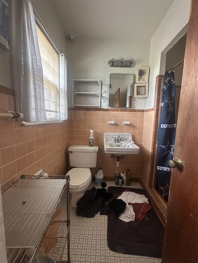 1407 Worthington St, Memphis, TN 38114 - bathroom with tile walls, a shower with curtain, and wainscoting