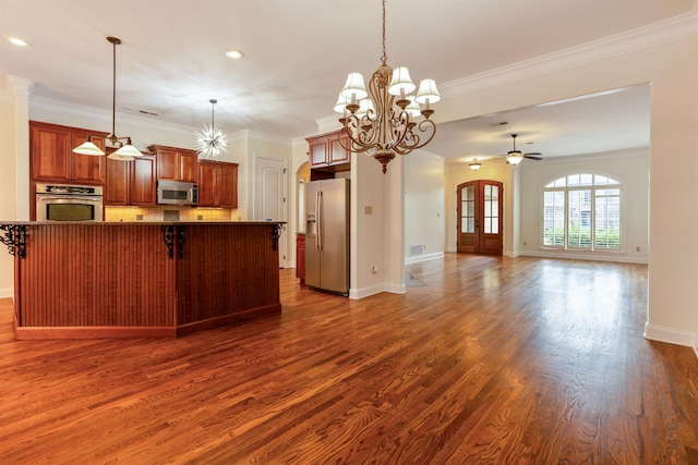 3485 E Taplow Way E, Collierville, TN 38017 - kitchen featuring stainless steel appliances, ornamental molding, dark wood-style floors, open floor plan, and arched walkways