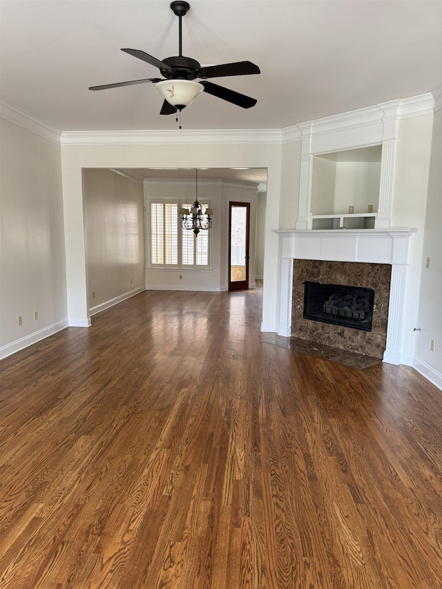 3485 E Taplow Way E, Collierville, TN 38017 - unfurnished living room featuring a chandelier, crown molding, a high end fireplace, ceiling fan, and dark wood-type flooring