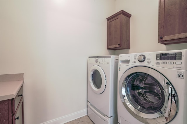 3485 E Taplow Way E, Collierville, TN 38017 - washroom with washing machine and clothes dryer, cabinet space, and light tile patterned floors