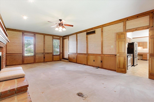 7802 Foster Ridge Dr, Germantown, TN 38138 - unfurnished living room with ceiling fan, a fireplace, a wainscoted wall, and light colored carpet