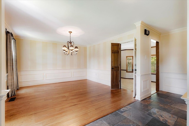 7802 Foster Ridge Dr, Germantown, TN 38138 - unfurnished room with a chandelier, ornamental molding, wainscoting, a decorative wall, and wood finished floors