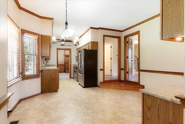 7802 Foster Ridge Dr, Germantown, TN 38138 - kitchen with appliances with stainless steel finishes, a chandelier, ornamental molding, light countertops, and hanging light fixtures