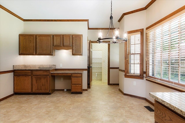 7802 Foster Ridge Dr, Germantown, TN 38138 - kitchen featuring a chandelier, crown molding, brown cabinets, built in study area, and pendant lighting