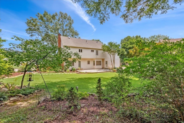 7802 Foster Ridge Dr, Germantown, TN 38138 - rear view of house with a patio area, a lawn, and a chimney