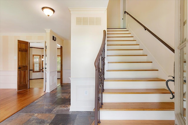 7802 Foster Ridge Dr, Germantown, TN 38138 - staircase featuring stone tile floors, wainscoting, a decorative wall, and ornamental molding