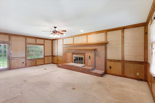 7802 Foster Ridge Dr, Germantown, TN 38138 - unfurnished living room featuring light carpet, ceiling fan, a fireplace, a textured ceiling, and a decorative wall