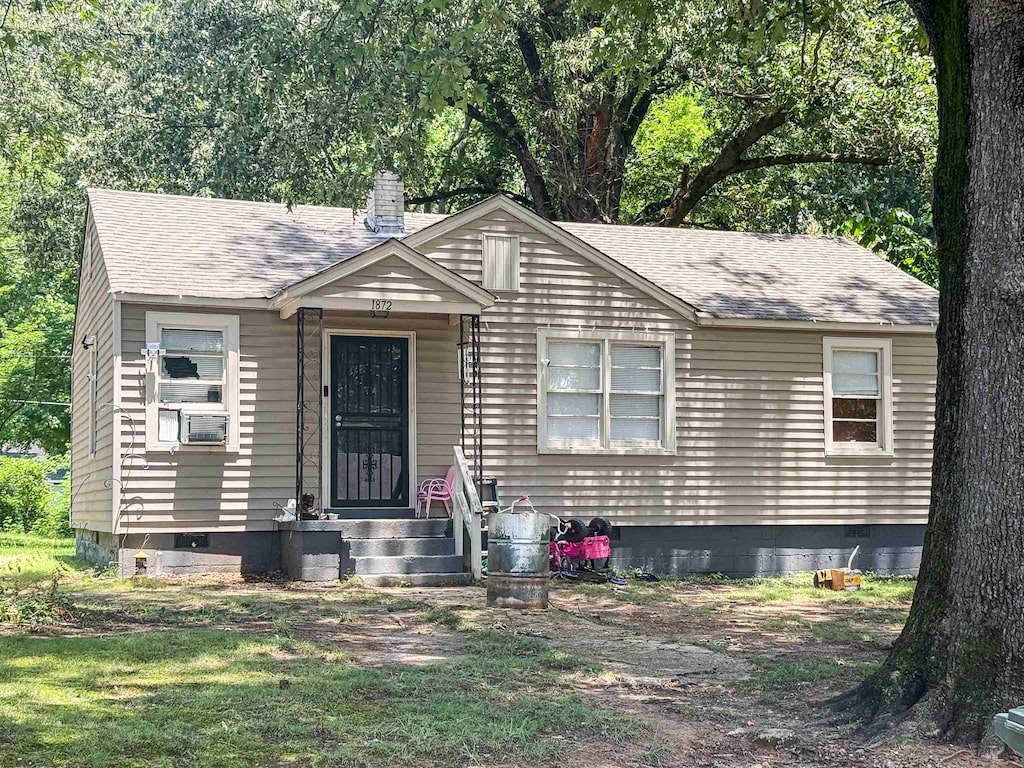 1872 Portland Ave, Memphis, TN 38127 - view of front facade with a chimney, roof with shingles, and crawl space