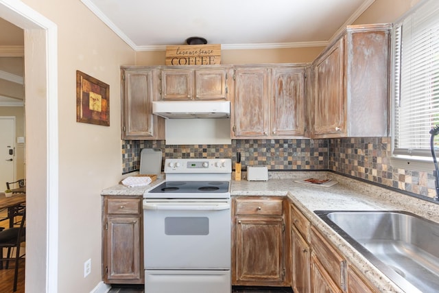 3541 Aurora Cir, Memphis, TN 38111 - kitchen featuring white electric stove, under cabinet range hood, decorative backsplash, light countertops, and crown molding