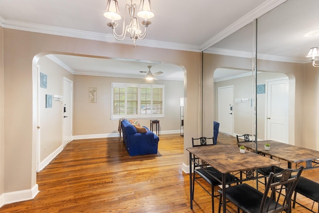 3541 Aurora Cir, Memphis, TN 38111 - dining space with arched walkways, light wood-type flooring, crown molding, and a chandelier