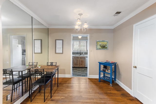 3541 Aurora Cir, Memphis, TN 38111 - dining area featuring wood finished floors, a chandelier, and crown molding