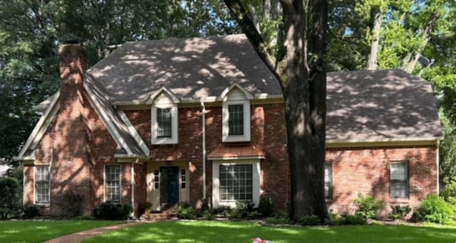 2108 Prestwick Dr, Germantown, TN 38139 - view of front facade featuring a front yard, a chimney, brick siding, and roof with shingles