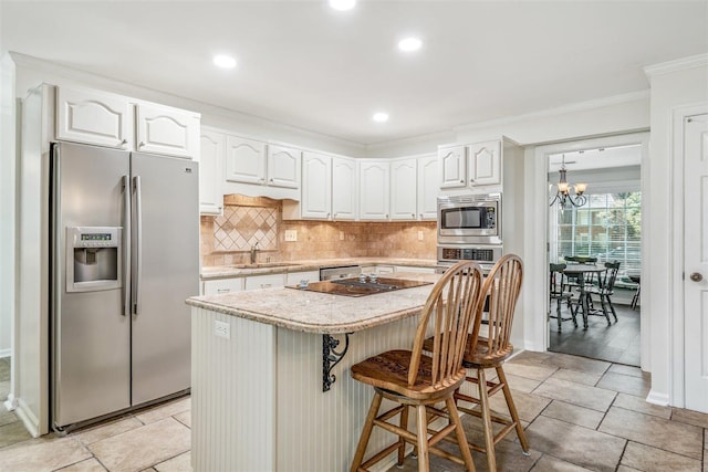 2108 Prestwick Dr, Germantown, TN 38139 - kitchen with stainless steel appliances, tasteful backsplash, ornamental molding, white cabinetry, and recessed lighting