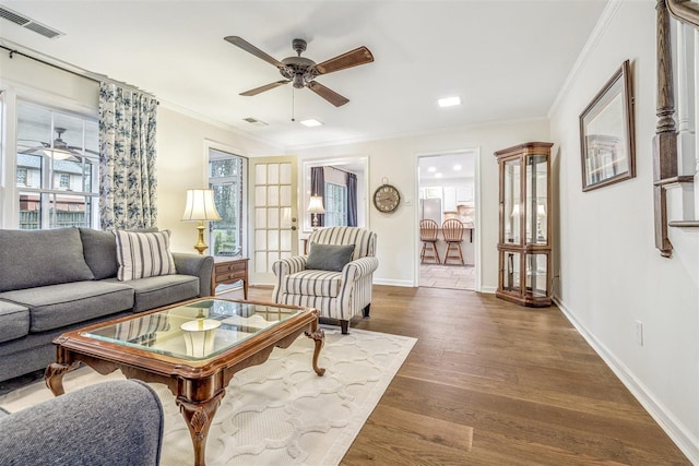 2108 Prestwick Dr, Germantown, TN 38139 - living area with ceiling fan, healthy amount of natural light, ornamental molding, and dark wood-style floors