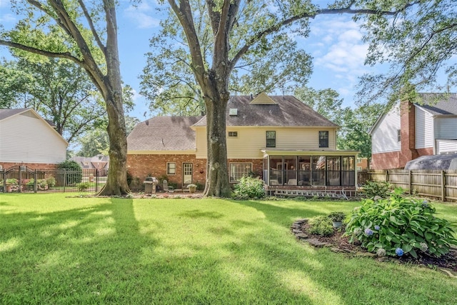2108 Prestwick Dr, Germantown, TN 38139 - rear view of house with brick siding, a sunroom, a fenced backyard, and roof with shingles