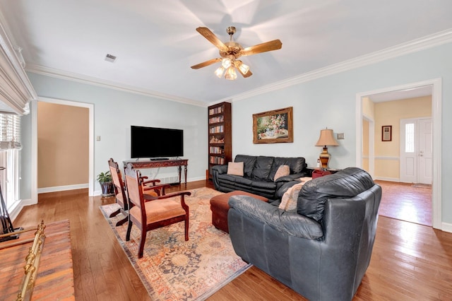 2671 Maple Grove Cv S, Germantown, TN 38139 - living area featuring healthy amount of natural light, ornamental molding, light wood-style floors, and ceiling fan
