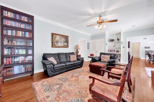 2671 Maple Grove Cv S, Germantown, TN 38139 - living room with ceiling fan, ornamental molding, wood finished floors, and built in shelves