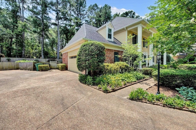 2671 Maple Grove Cv S, Germantown, TN 38139 - view of home's exterior featuring concrete driveway, an attached garage, brick siding, and roof with shingles