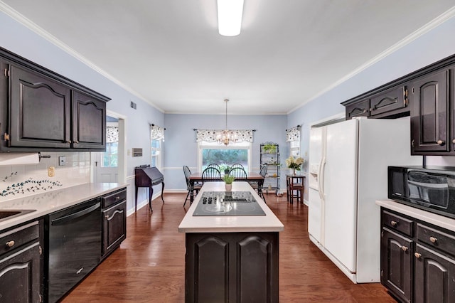 2671 Maple Grove Cv S, Germantown, TN 38139 - kitchen with black appliances, a kitchen island, a chandelier, light countertops, and dark wood-type flooring
