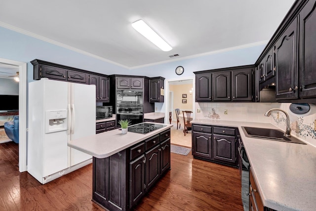 2671 Maple Grove Cv S, Germantown, TN 38139 - kitchen featuring black appliances, a center island, dark wood-type flooring, ornamental molding, and light countertops