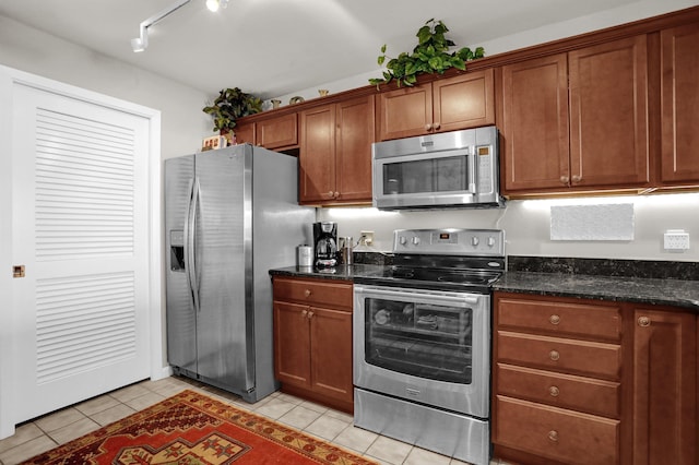 200 Wagner Pl Unit 804, Memphis, TN 38103 - kitchen featuring stainless steel appliances, light tile patterned floors, and brown cabinets