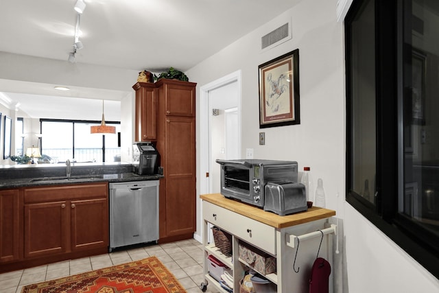 200 Wagner Pl Unit 804, Memphis, TN 38103 - kitchen with stainless steel dishwasher, light tile patterned floors, brown cabinets, and wood counters