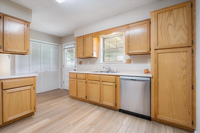 3333 Sycamore View Rd, Bartlett, TN 38134 - kitchen with stainless steel dishwasher, light wood-type flooring, light countertops, a textured ceiling, and light brown cabinetry