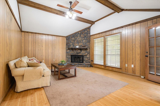 3333 Sycamore View Rd, Bartlett, TN 38134 - living room featuring wood finished floors, wooden walls, ceiling fan, and a stone fireplace