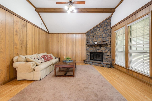 3333 Sycamore View Rd, Bartlett, TN 38134 - living area featuring light wood-style flooring, ceiling fan, a stone fireplace, and wood walls